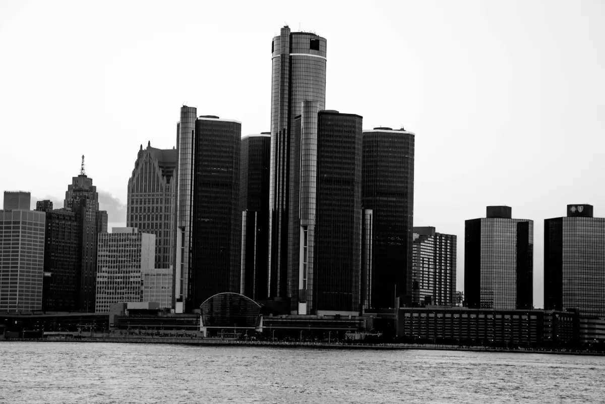 Black-and-white view of the downtown Detroit skyline across the Detroit River.